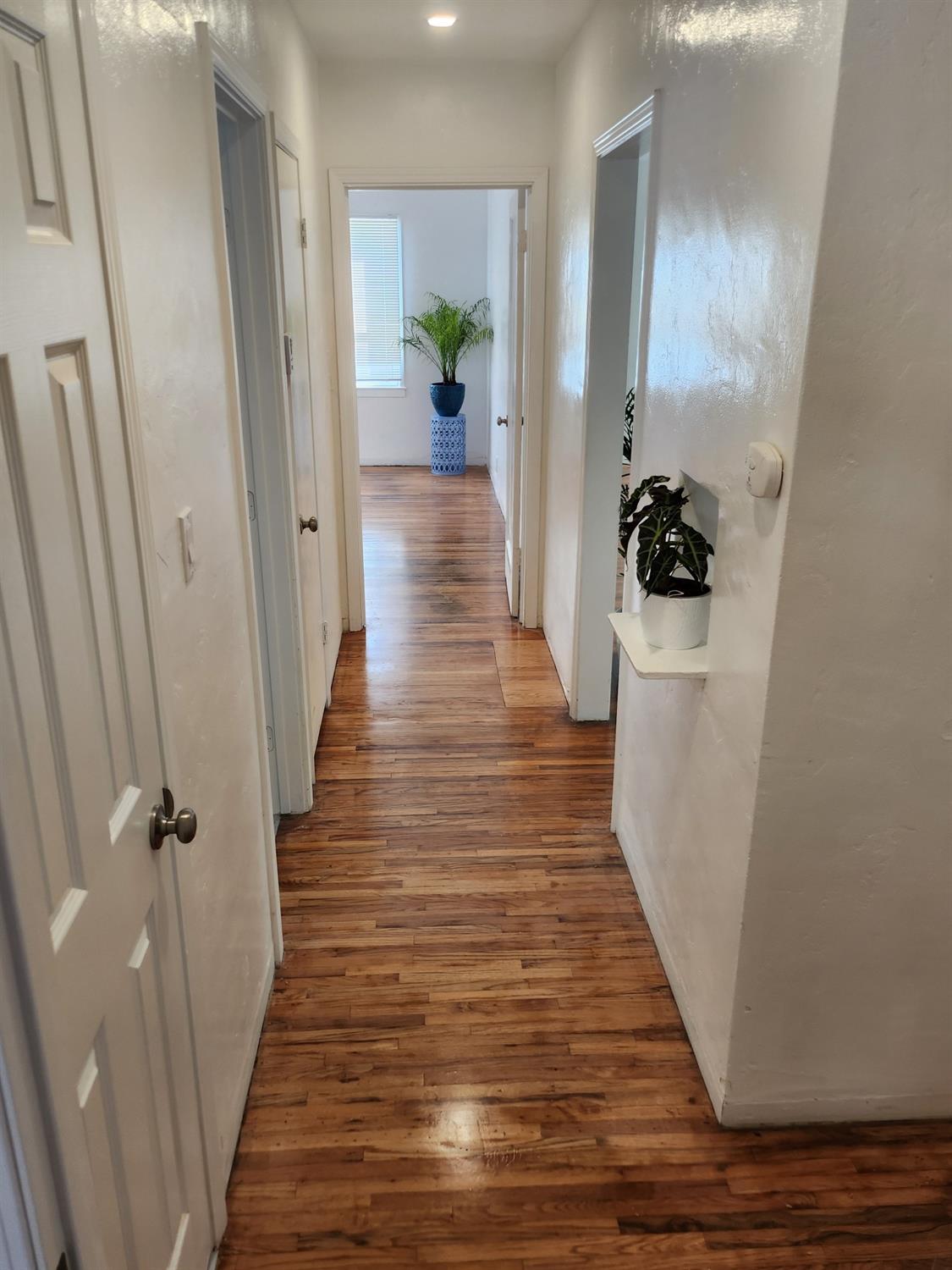 2011 11th Street Reedley, CA 93654 - Photo 6 of 17 a view of a hallway with wooden floor and staircase
