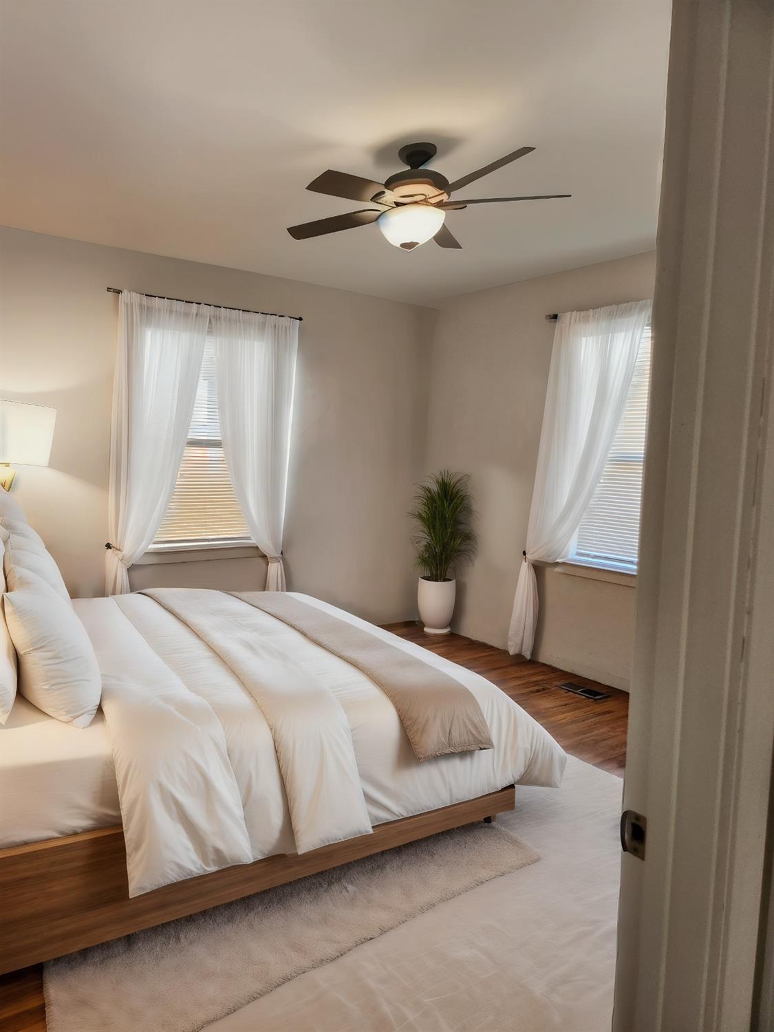 2011 11th Street Reedley, CA 93654 - Photo 7 of 17 a bedroom with a bed and a window