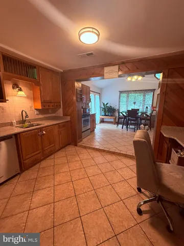 a kitchen with stainless steel appliances kitchen island granite countertop a sink and cabinets