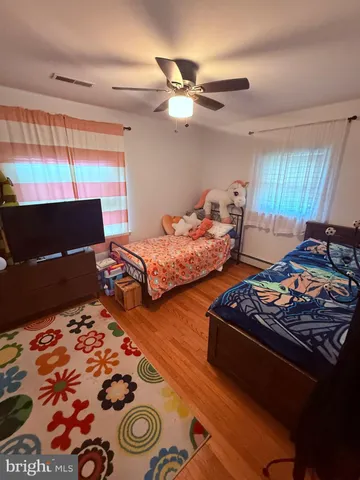 a bedroom with two beds and a window