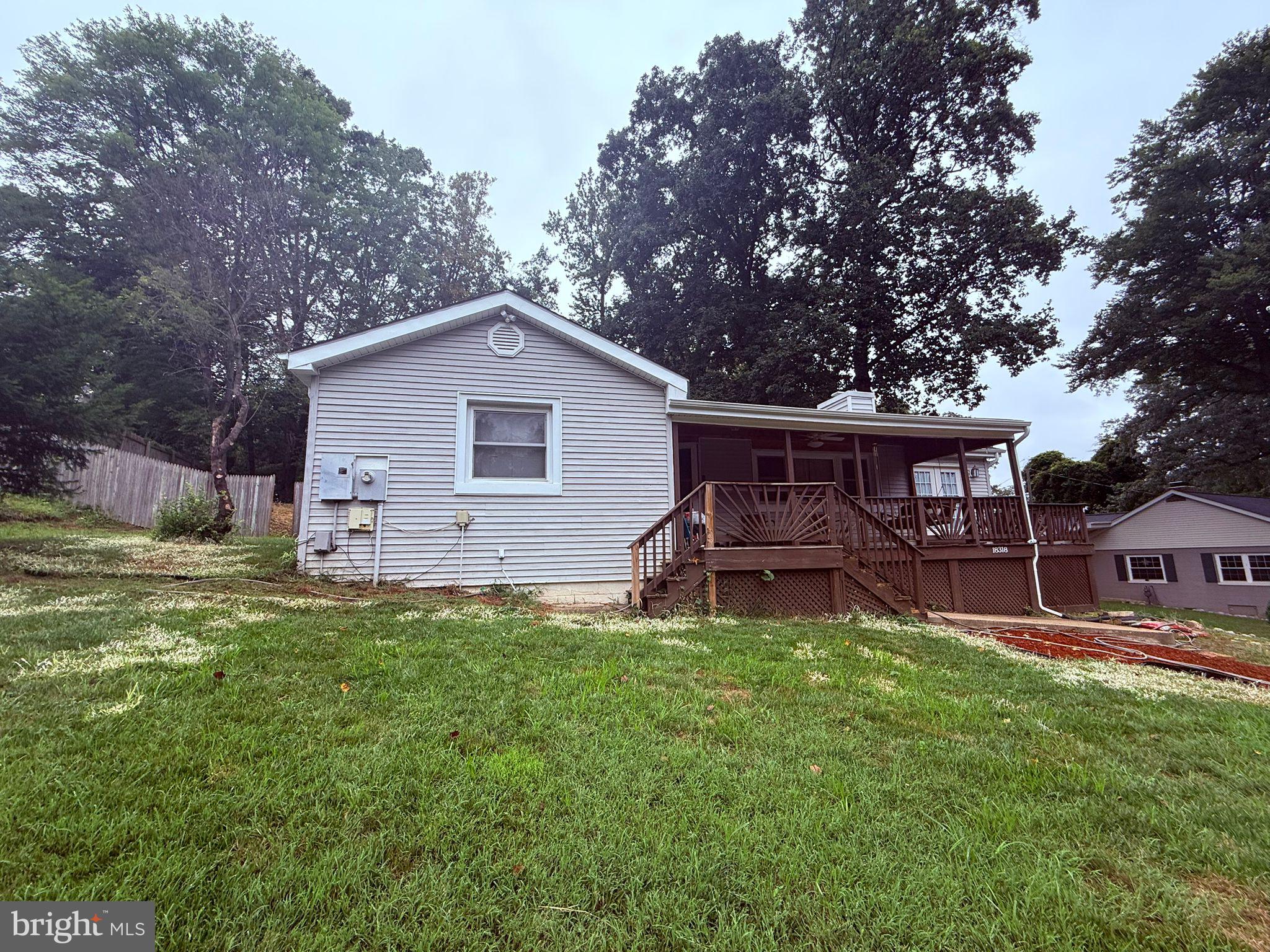 18318 Sharon Road Triangle, VA 22172 - Photo 2 of 27 a front view of a house with a garden and trees