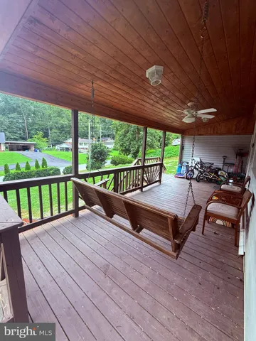 a view of a deck with wooden floor and outdoor seating