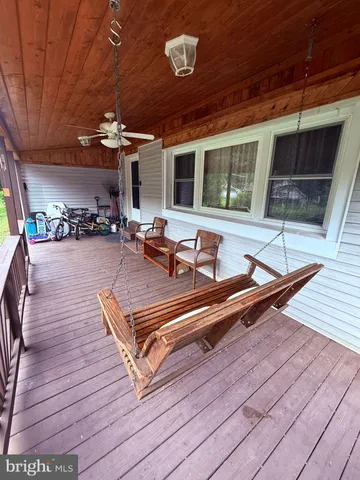 a view of a roof deck with table and chairs with wooden floor