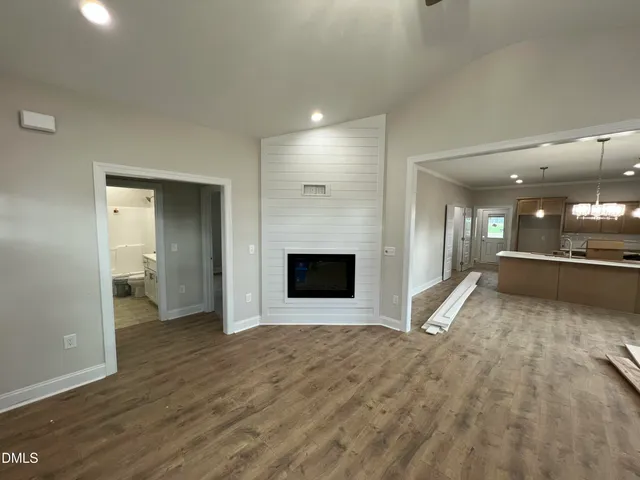 an empty room with fan and fireplace