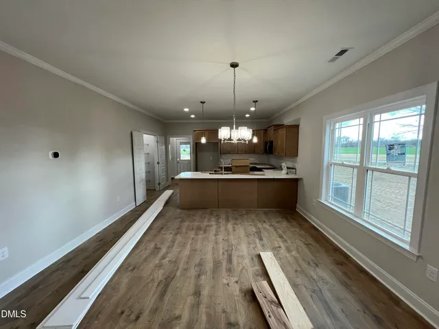 a view of a big room with a fireplace and a chandelier