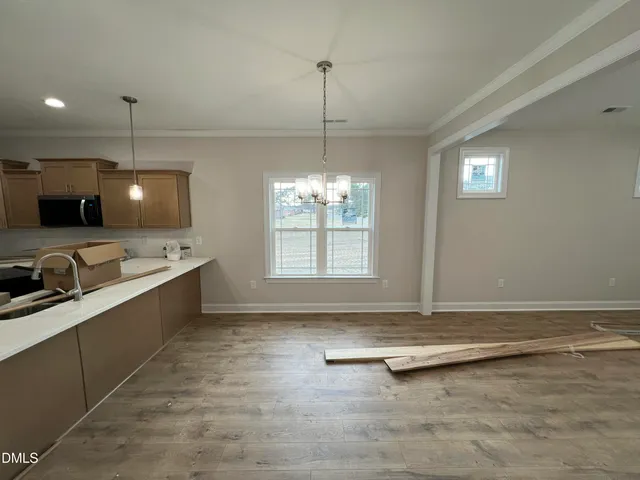 a view of a kitchen with a sink and wooden floor