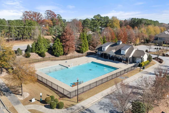 a view of a swimming pool with a yard and seating area