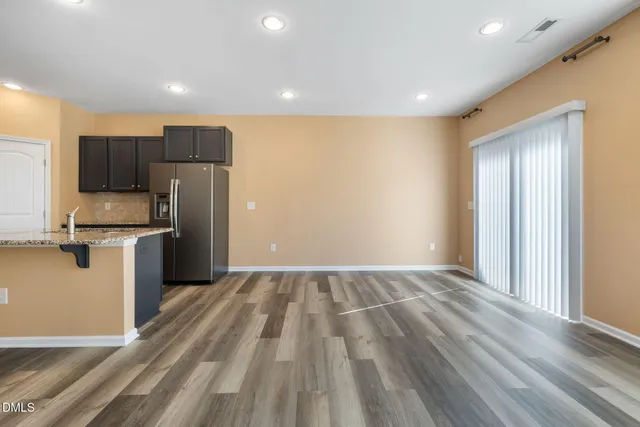 a view of kitchen with refrigerator stove microwave and cabinets