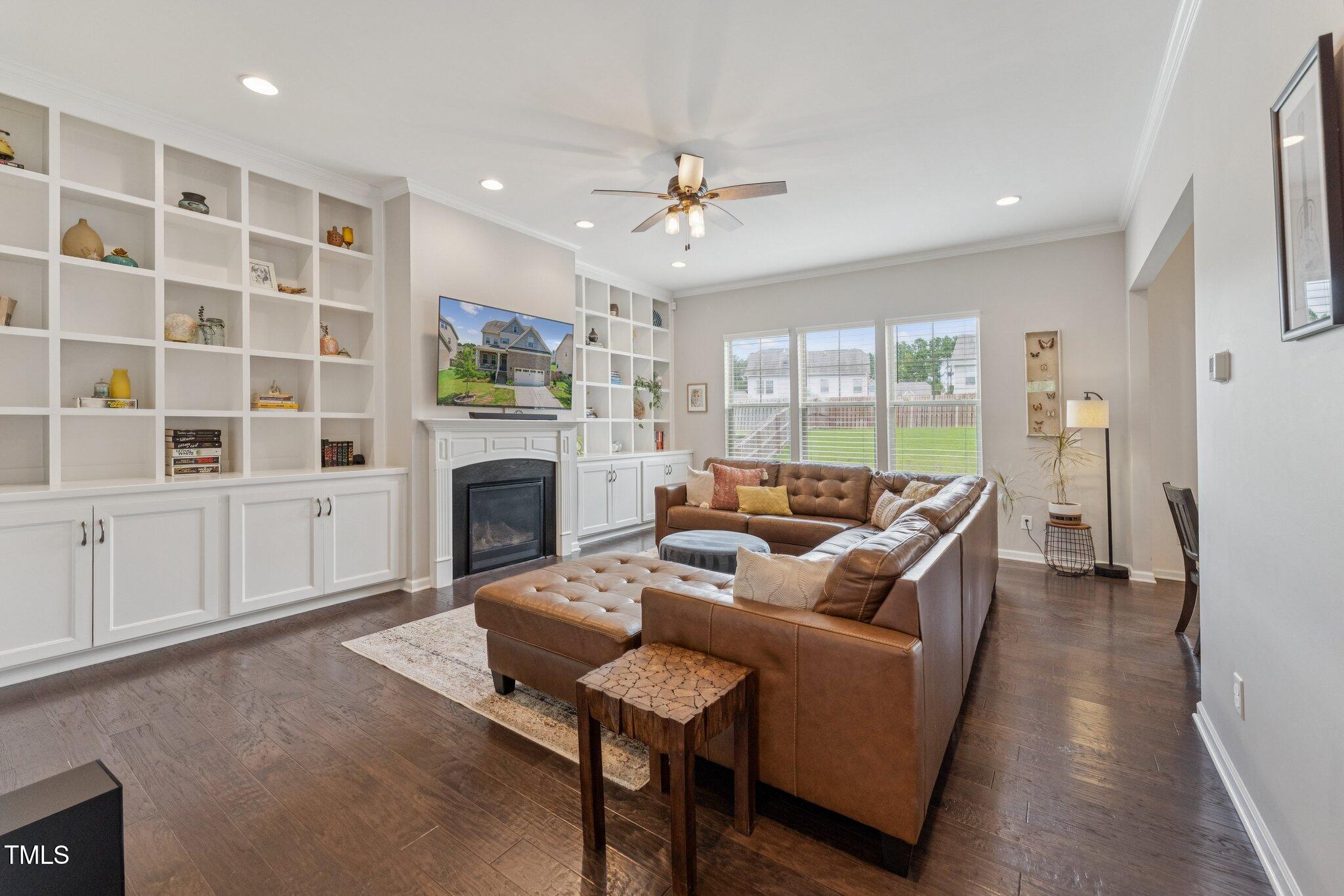 1020 Big Spring Circle Durham, NC 27703 - Photo 6 of 40 a living room with furniture a fireplace and a flat screen tv