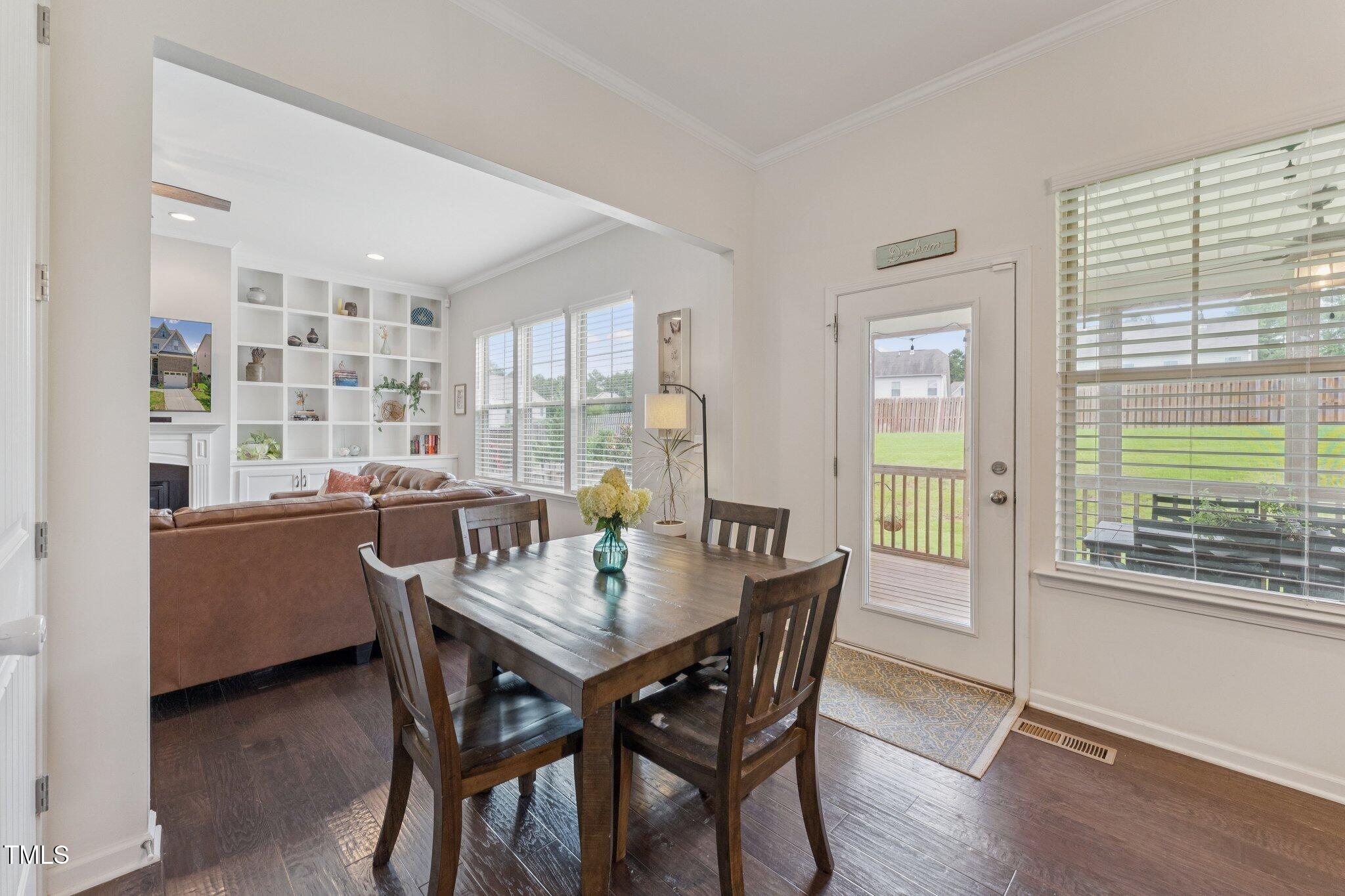 1020 Big Spring Circle Durham, NC 27703 - Photo 10 of 40 a view of a dining room with furniture and a potted plant