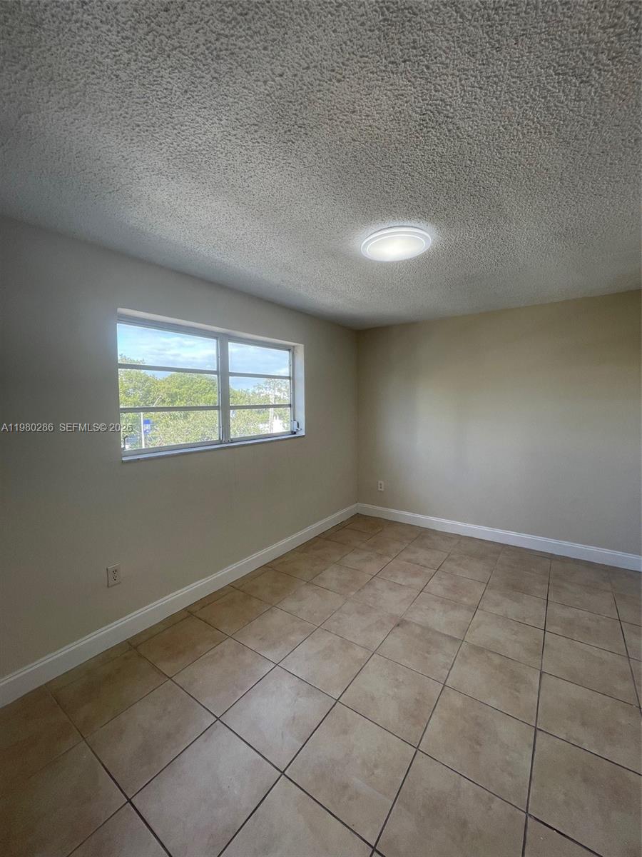 2500 Southwest 6th Street, Unit 404 Miami, FL 33135 - Photo 12 of 19 an empty room with a window