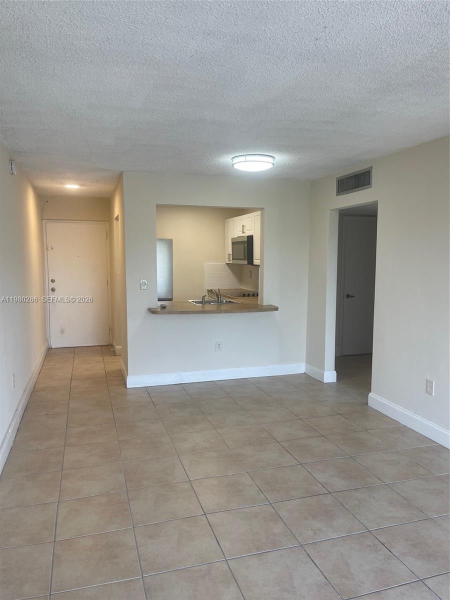 2500 Southwest 6th Street, Unit 404 Miami, FL 33135 - Photo 7 of 19 a view of a sink and a refrigerator in a room