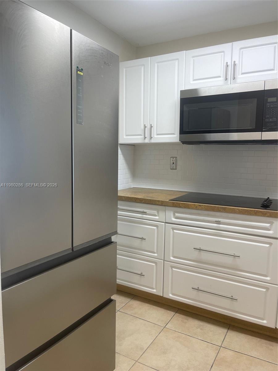 2500 Southwest 6th Street, Unit 404 Miami, FL 33135 - Photo 8 of 19 a kitchen with cabinets and steel stainless steel appliances
