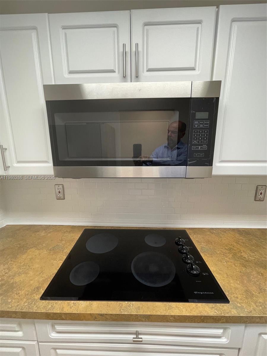 2500 Southwest 6th Street, Unit 404 Miami, FL 33135 - Photo 10 of 19 a kitchen with a stove and a microwave
