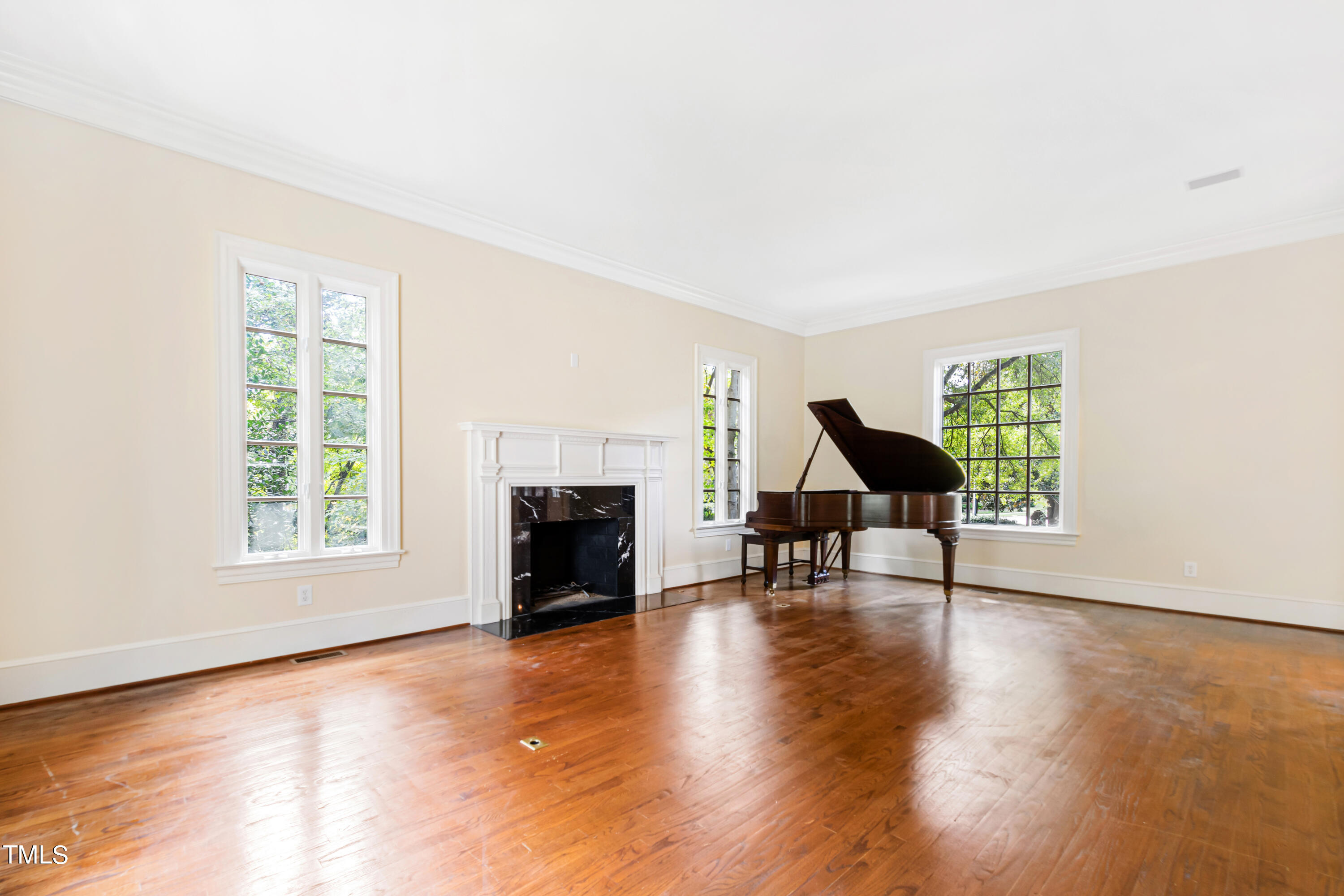 2825 Lassiter Mill Road Raleigh, NC 27609 - Photo 5 of 30 a view of empty room with fireplace and wooden floor