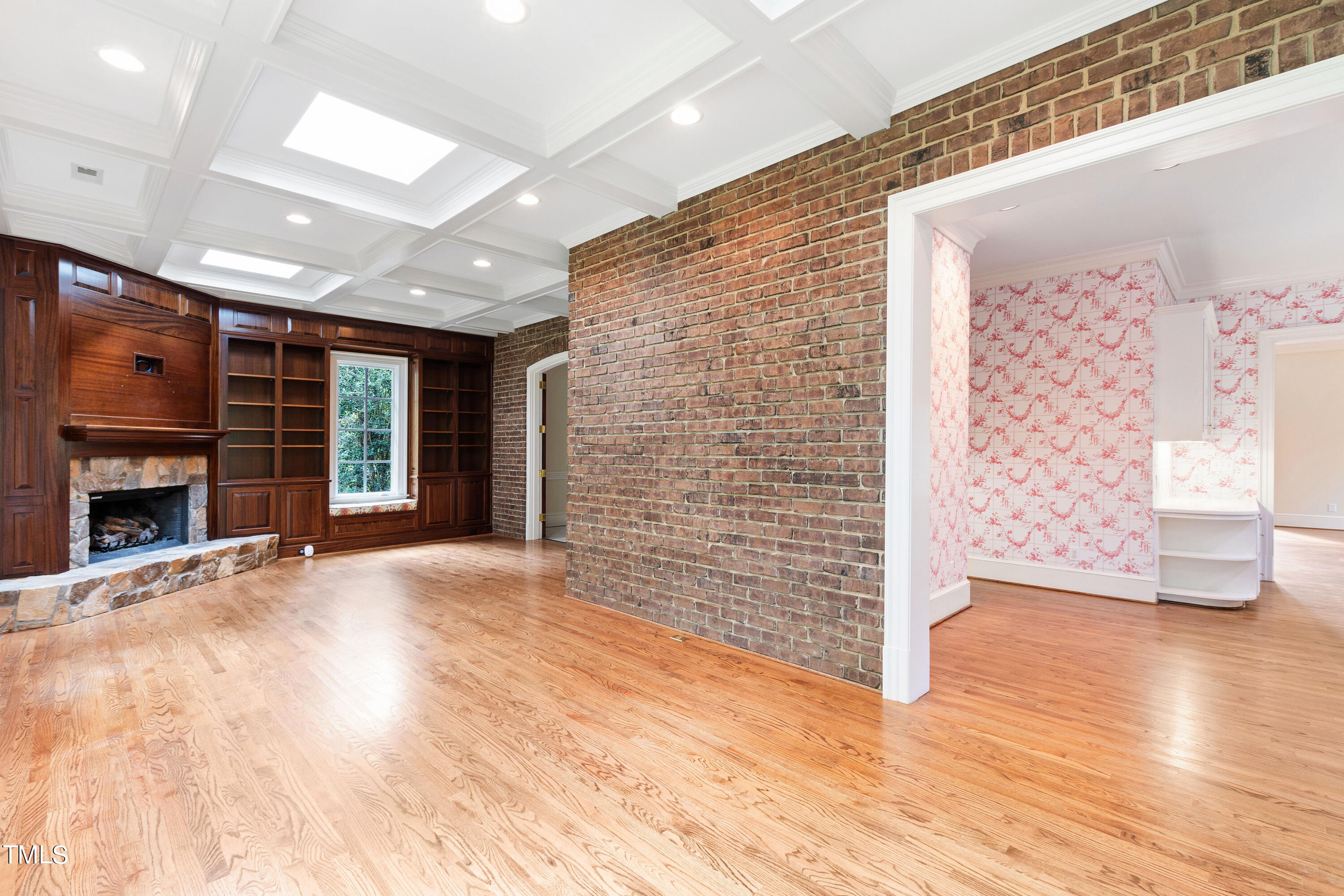 2825 Lassiter Mill Road Raleigh, NC 27609 - Photo 8 of 30 a view of an empty room with wooden floor and a fireplace