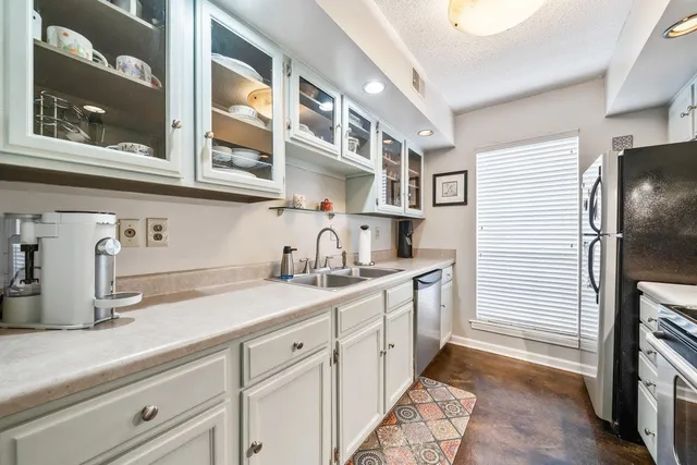 a kitchen with a sink and cabinets