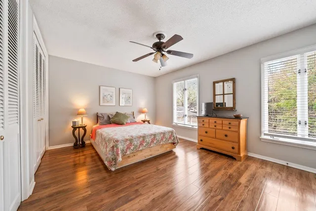 a bedroom with a bed and wooden floor