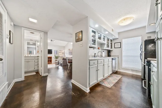a view of kitchen with furniture and refrigerator