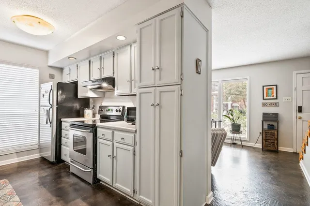 a kitchen with stainless steel appliances a refrigerator sink and cabinets