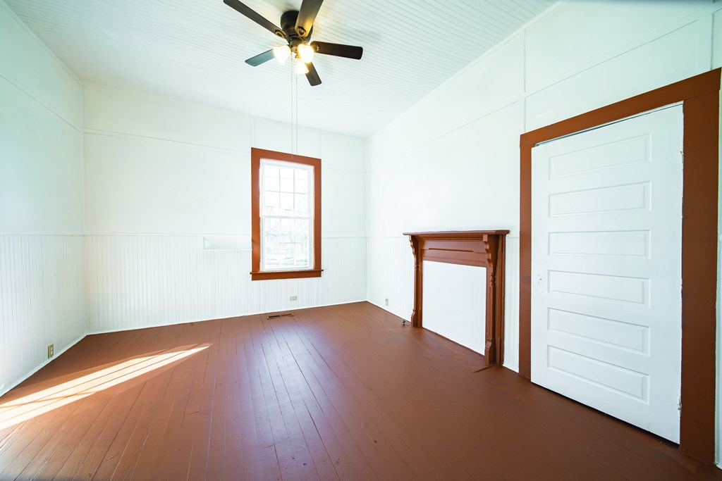13 Perry Street Manchester, GA 31816 - Photo 11 of 24 an empty room with wooden floor closet and windows