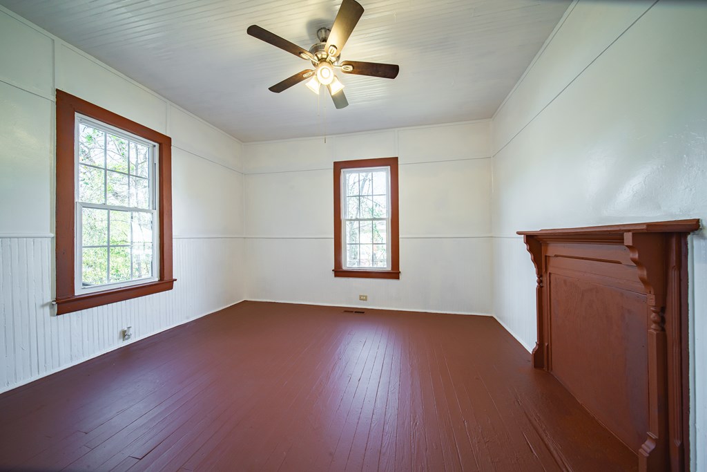 13 Perry Street Manchester, GA 31816 - Photo 14 of 24 a view of an empty room with wooden floor and a window