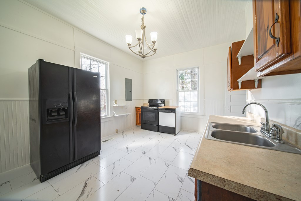 13 Perry Street Manchester, GA 31816 - Photo 19 of 24 a kitchen with granite countertop a refrigerator and a sink