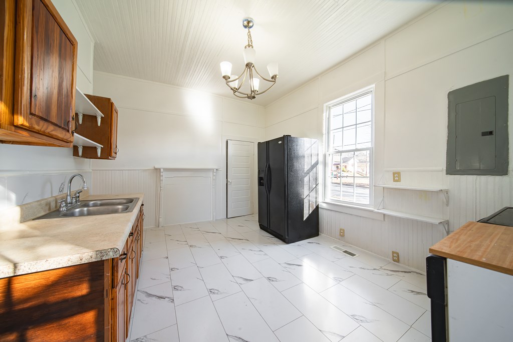 13 Perry Street Manchester, GA 31816 - Photo 20 of 24 a kitchen with a refrigerator a sink and a stove top oven