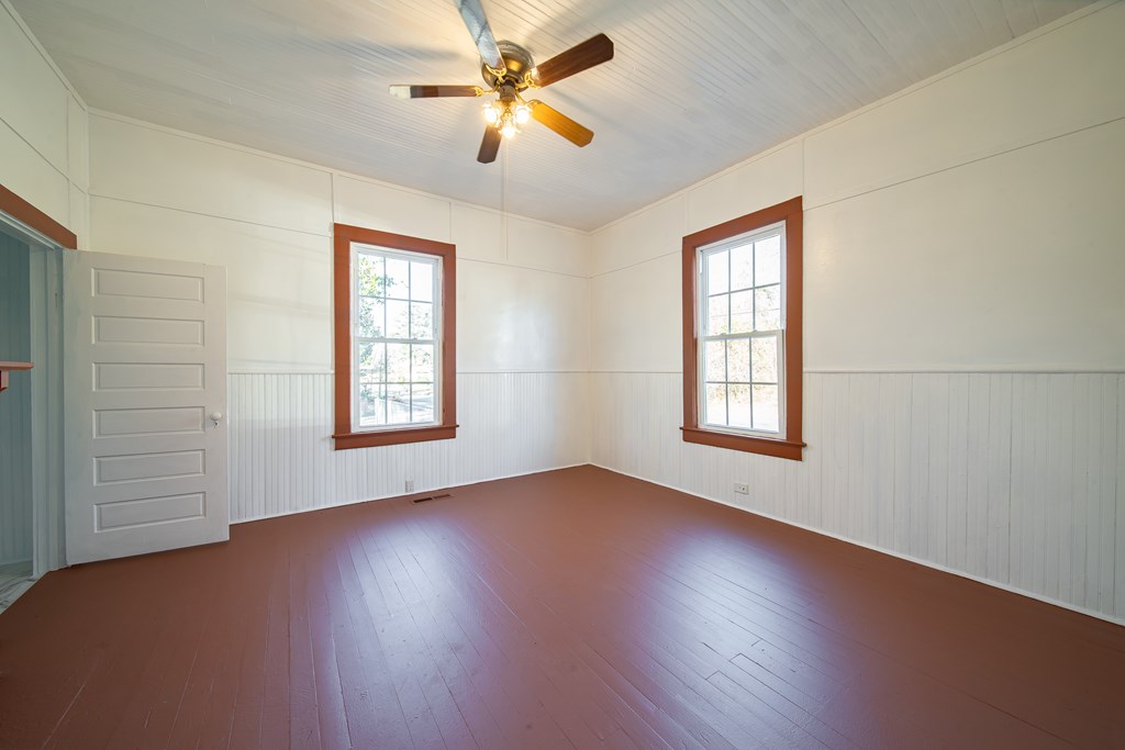 13 Perry Street Manchester, GA 31816 - Photo 9 of 24 wooden floor in an empty room with a window