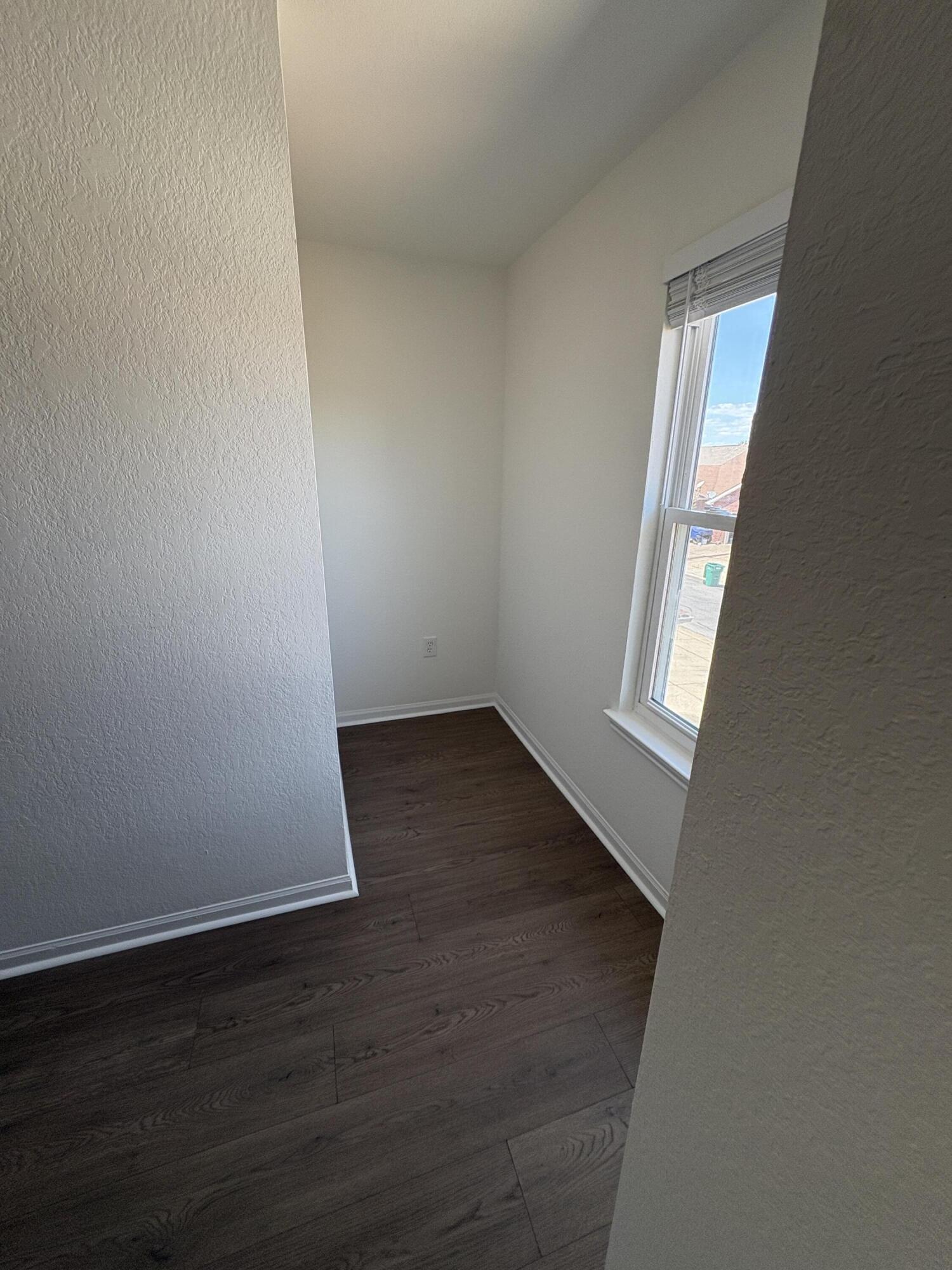1014 Airport Road, Unit 138 Destin, FL 32541 - Photo 10 of 21 an empty room with wooden floor and windows