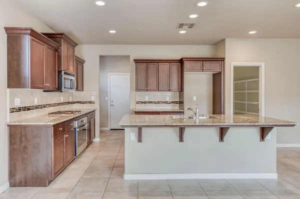 a kitchen with stainless steel appliances granite countertop a stove and a sink