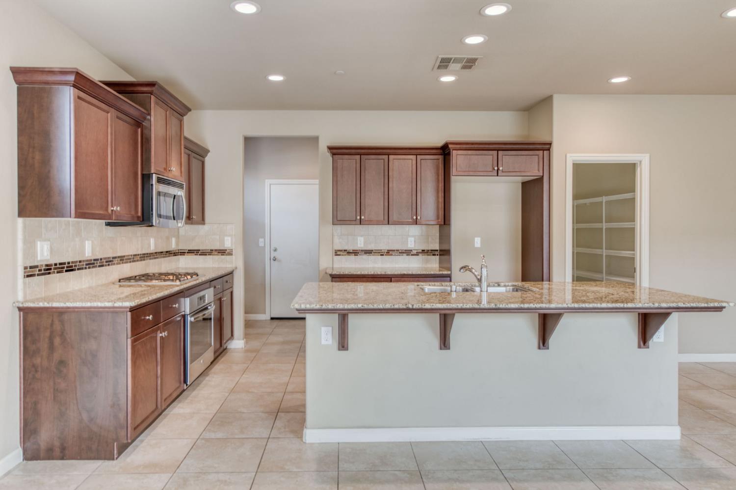 a kitchen with stainless steel appliances granite countertop a stove and a sink