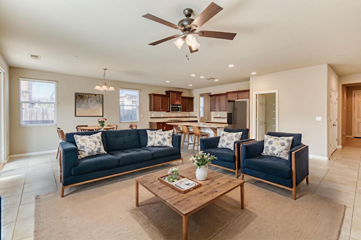 3460 Griffith Avenue Clovis, CA 93619 - Photo 11 of 28 a living room with furniture kitchen view and a chandelier