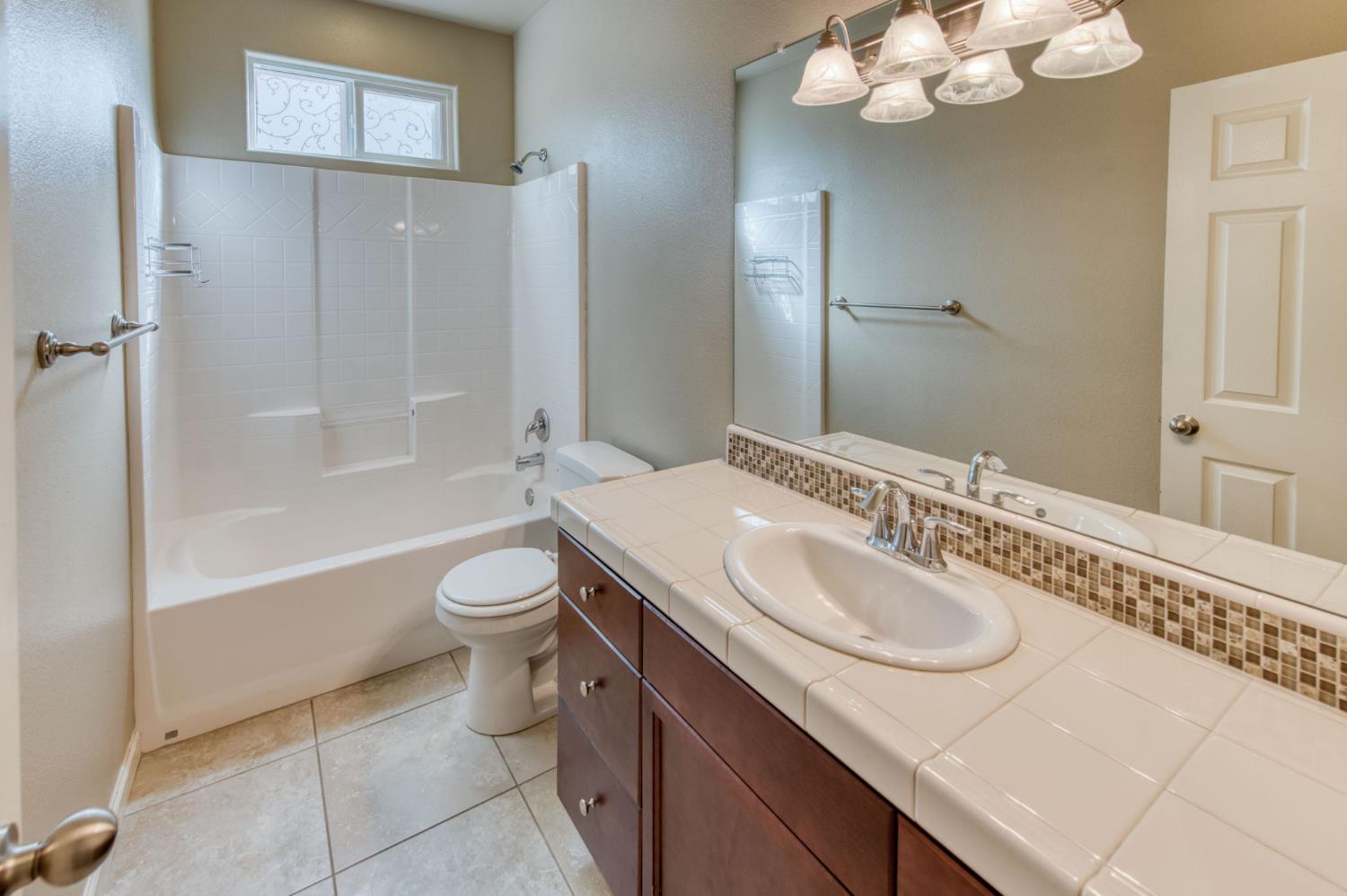 3460 Griffith Avenue Clovis, CA 93619 - Photo 14 of 28 a bathroom with a granite countertop sink toilet and shower