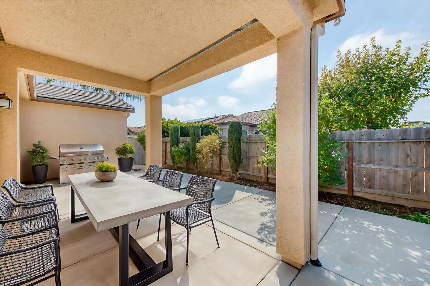 3460 Griffith Avenue Clovis, CA 93619 - Photo 21 of 28 a view of an outdoor dining space with a table and chairs