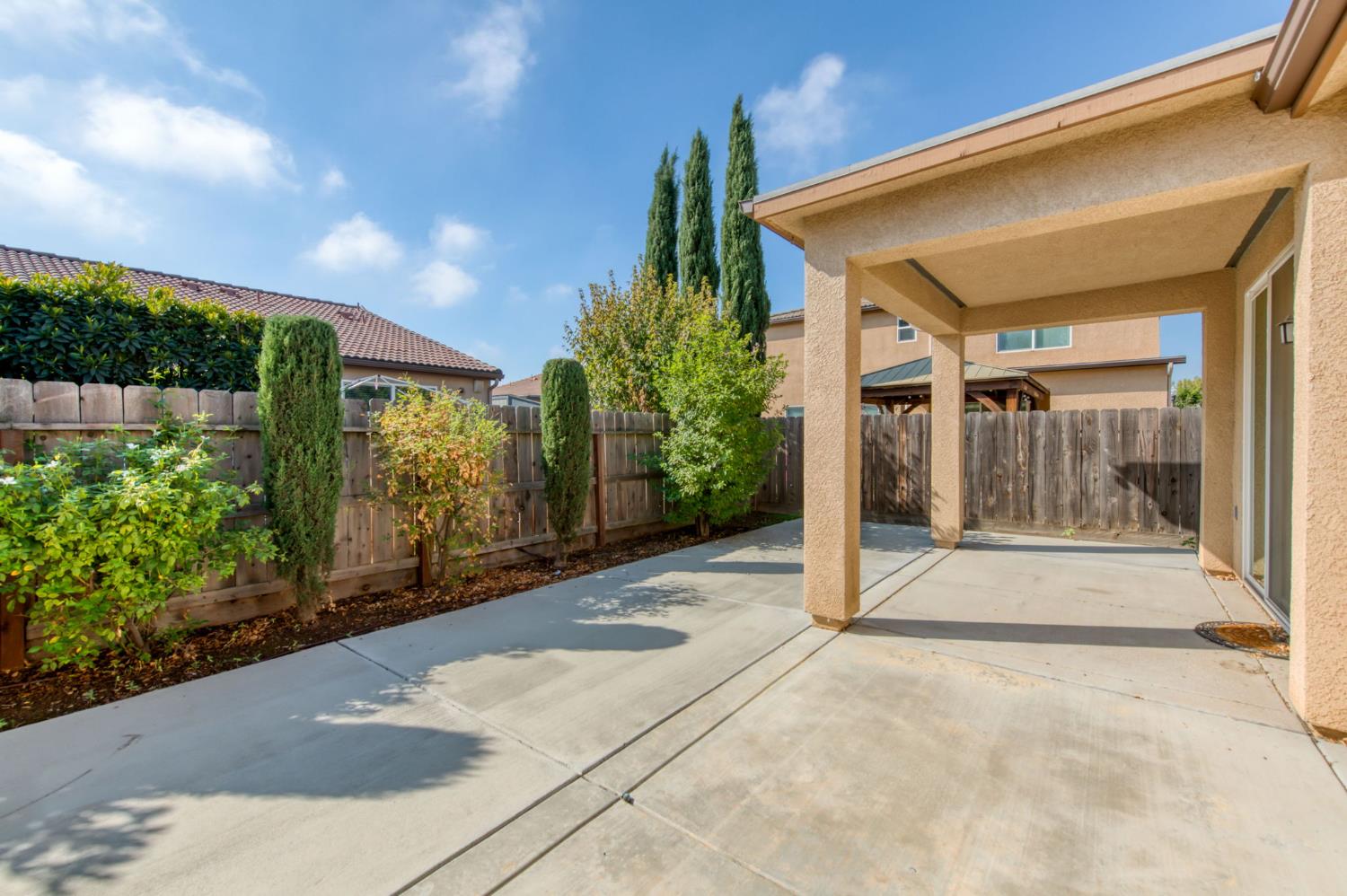 3460 Griffith Avenue Clovis, CA 93619 - Photo 26 of 28 a view of a house with porch and floor to ceiling windows