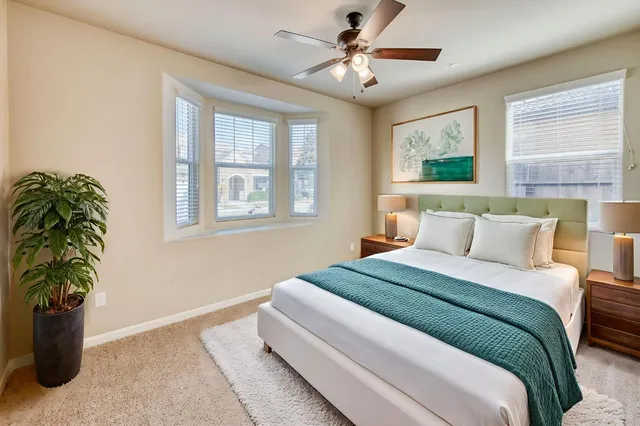 a bedroom with bed and a window