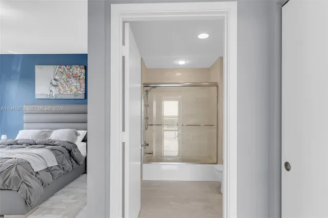 a bedroom with a large bed and a window