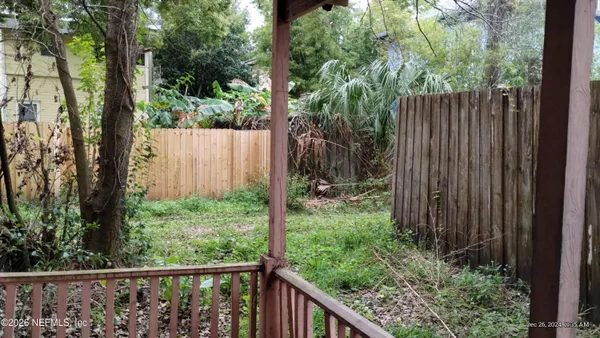 a view of a fence in the forest