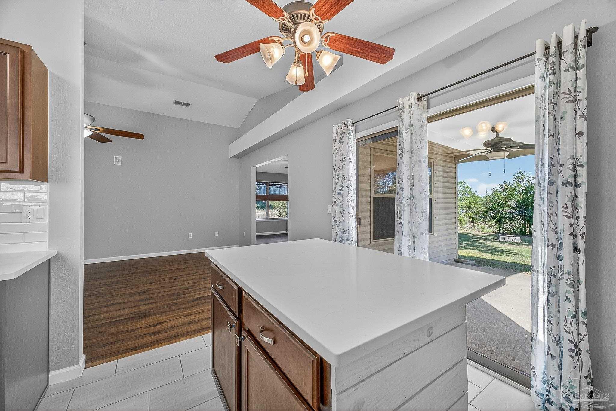 272 Millet Circle Cantonment, FL 32533 - Photo 12 of 57 a kitchen with a stove a refrigerator a sink and a large window