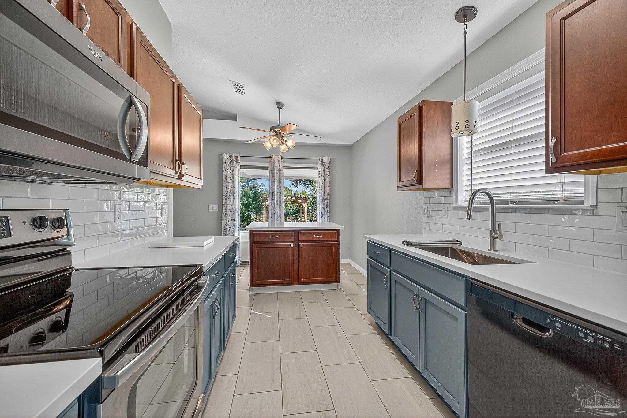 272 Millet Circle Cantonment, FL 32533 - Photo 2 of 57 a kitchen with a sink stove and cabinets