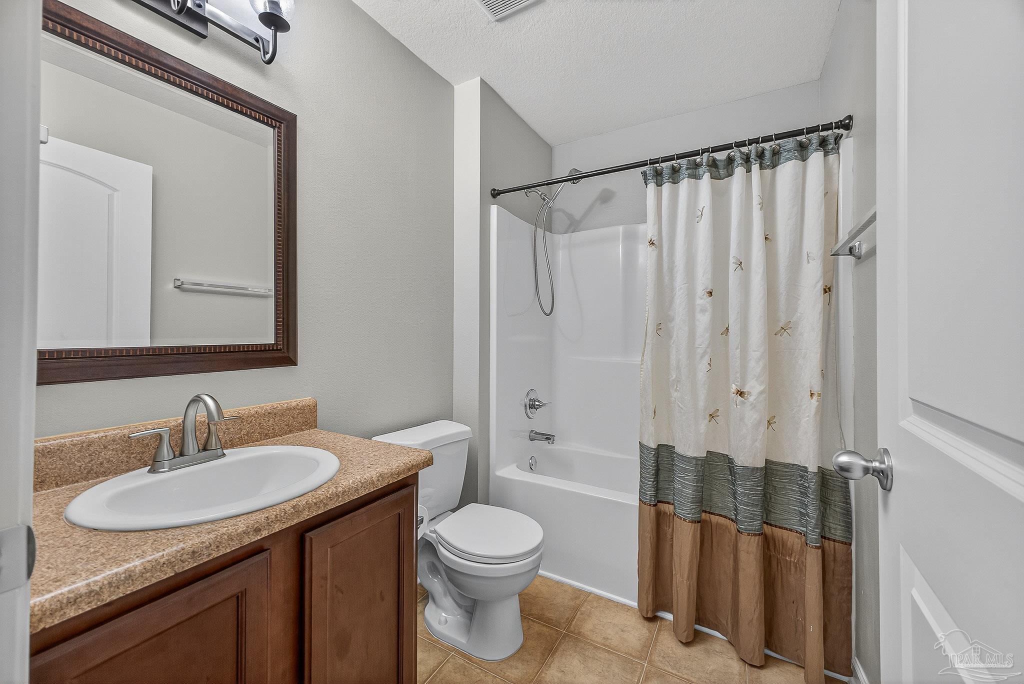 272 Millet Circle Cantonment, FL 32533 - Photo 26 of 57 a bathroom with a granite countertop sink toilet and shower