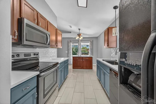 a kitchen with stainless steel appliances granite countertop a stove and a sink
