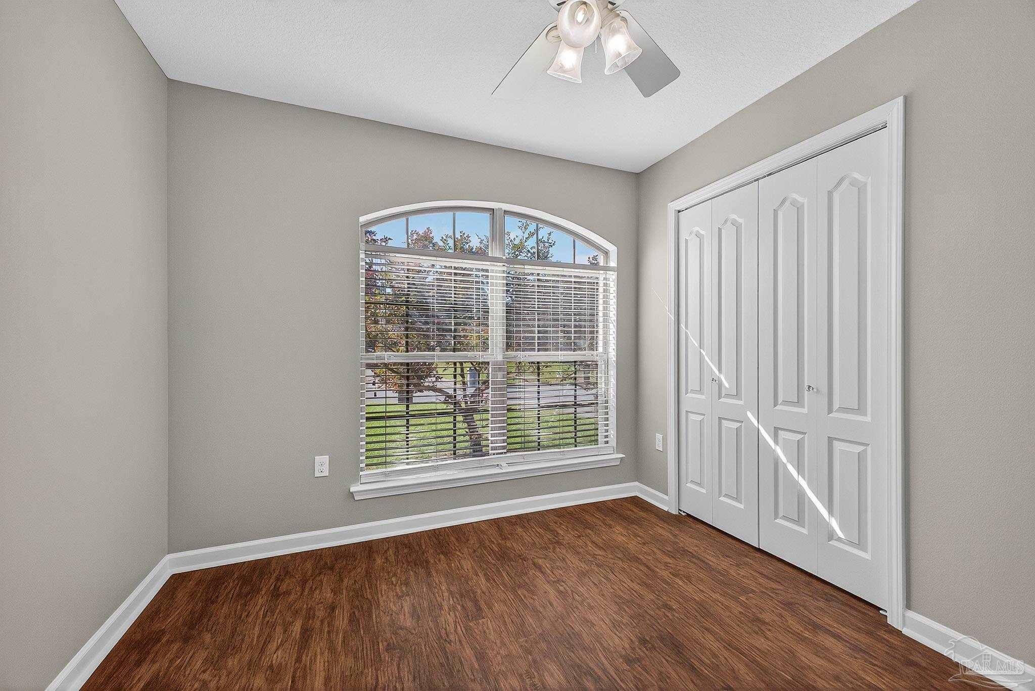 272 Millet Circle Cantonment, FL 32533 - Photo 35 of 57 a view of an empty room with a window and wooden floor