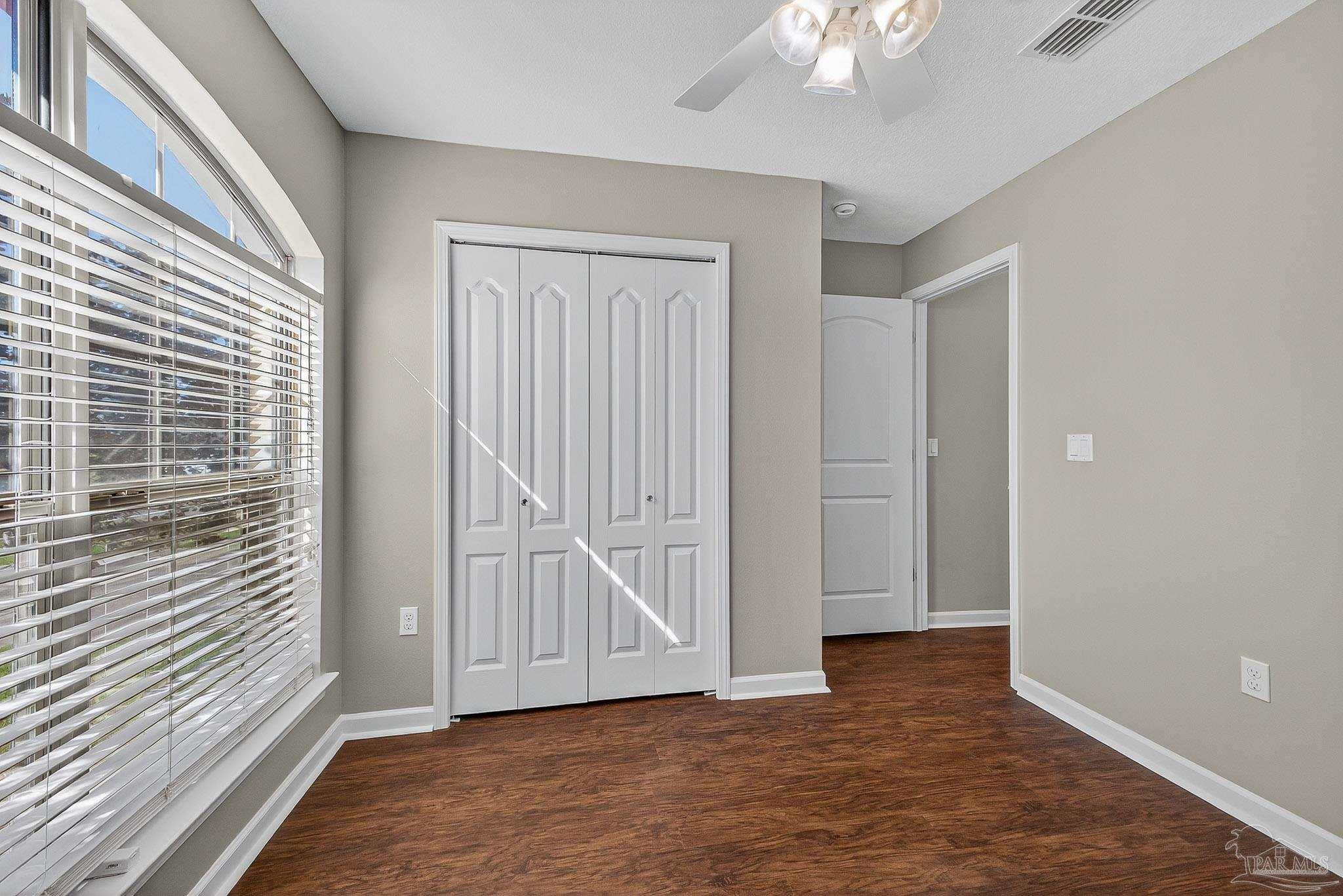 272 Millet Circle Cantonment, FL 32533 - Photo 36 of 57 a view of an empty room with wooden floor and a window