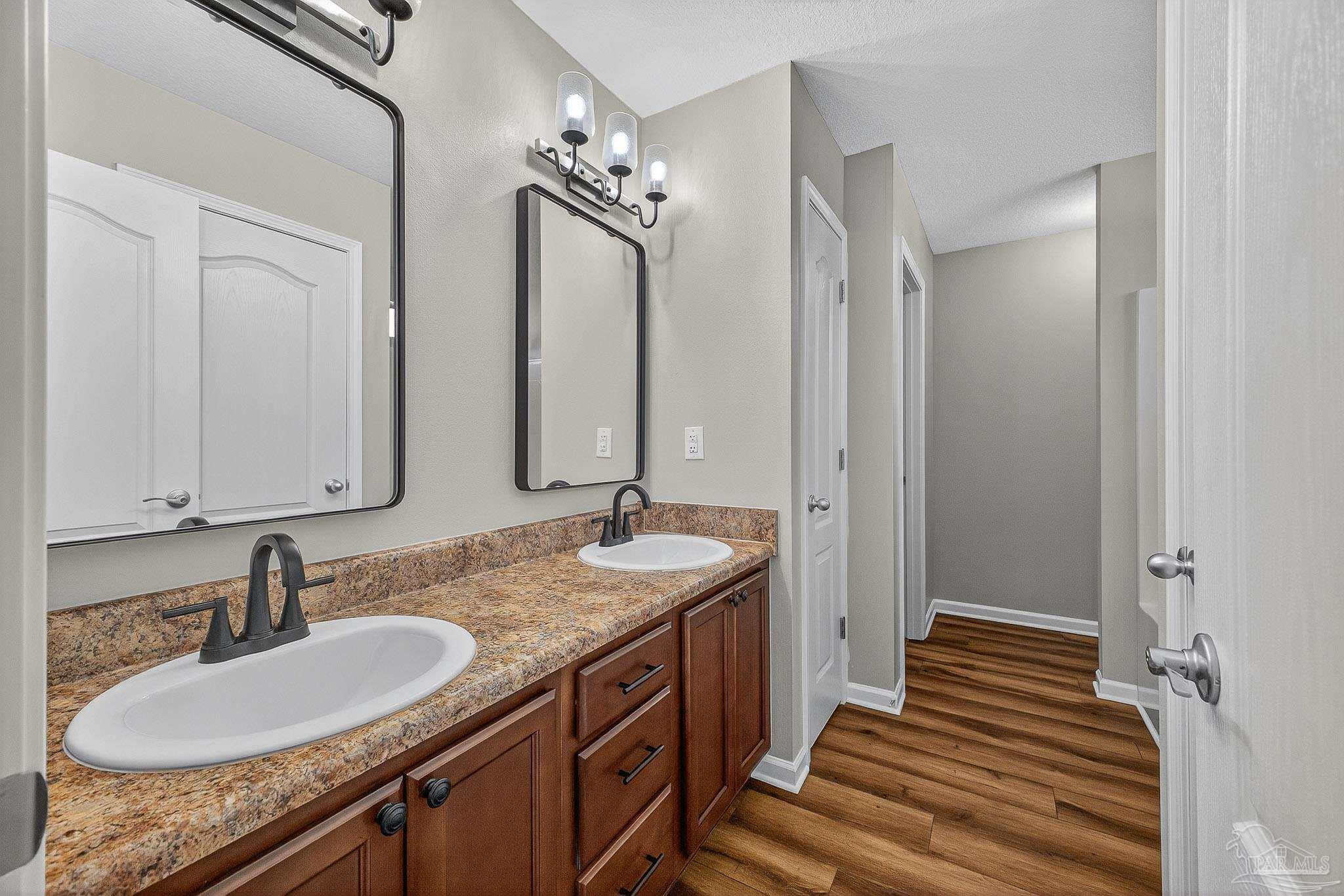 272 Millet Circle Cantonment, FL 32533 - Photo 41 of 57 a bathroom with a granite countertop double vanity sink and a mirror
