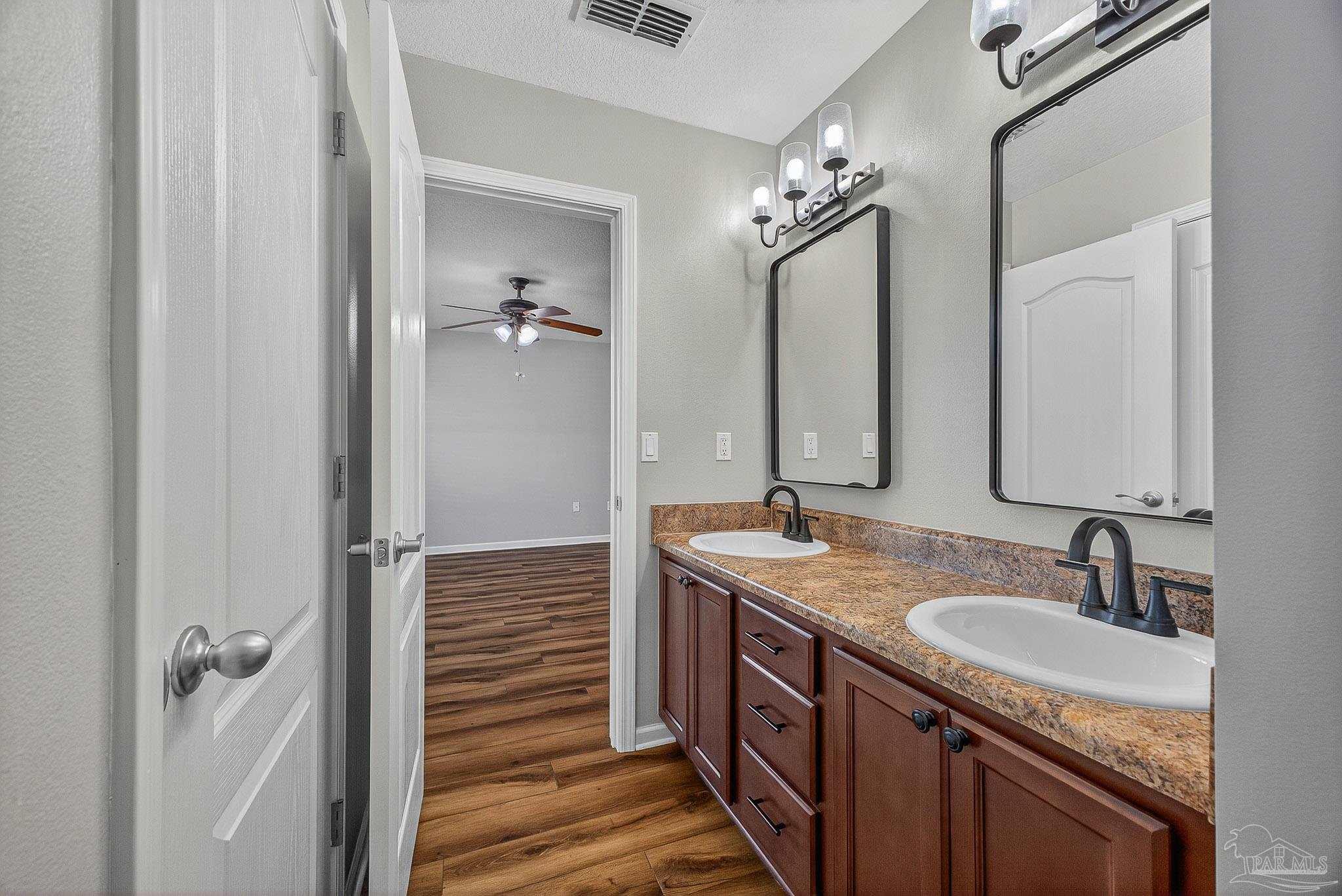 272 Millet Circle Cantonment, FL 32533 - Photo 42 of 57 a bathroom with a granite countertop sink a mirror and a shower