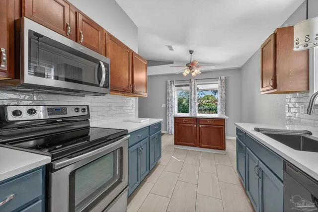 a kitchen with a stove microwave and sink