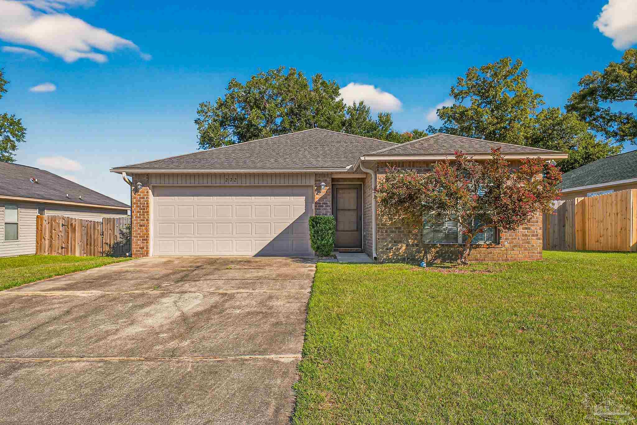 272 Millet Circle Cantonment, FL 32533 - Photo 57 of 57 a view of a house with a yard and garage