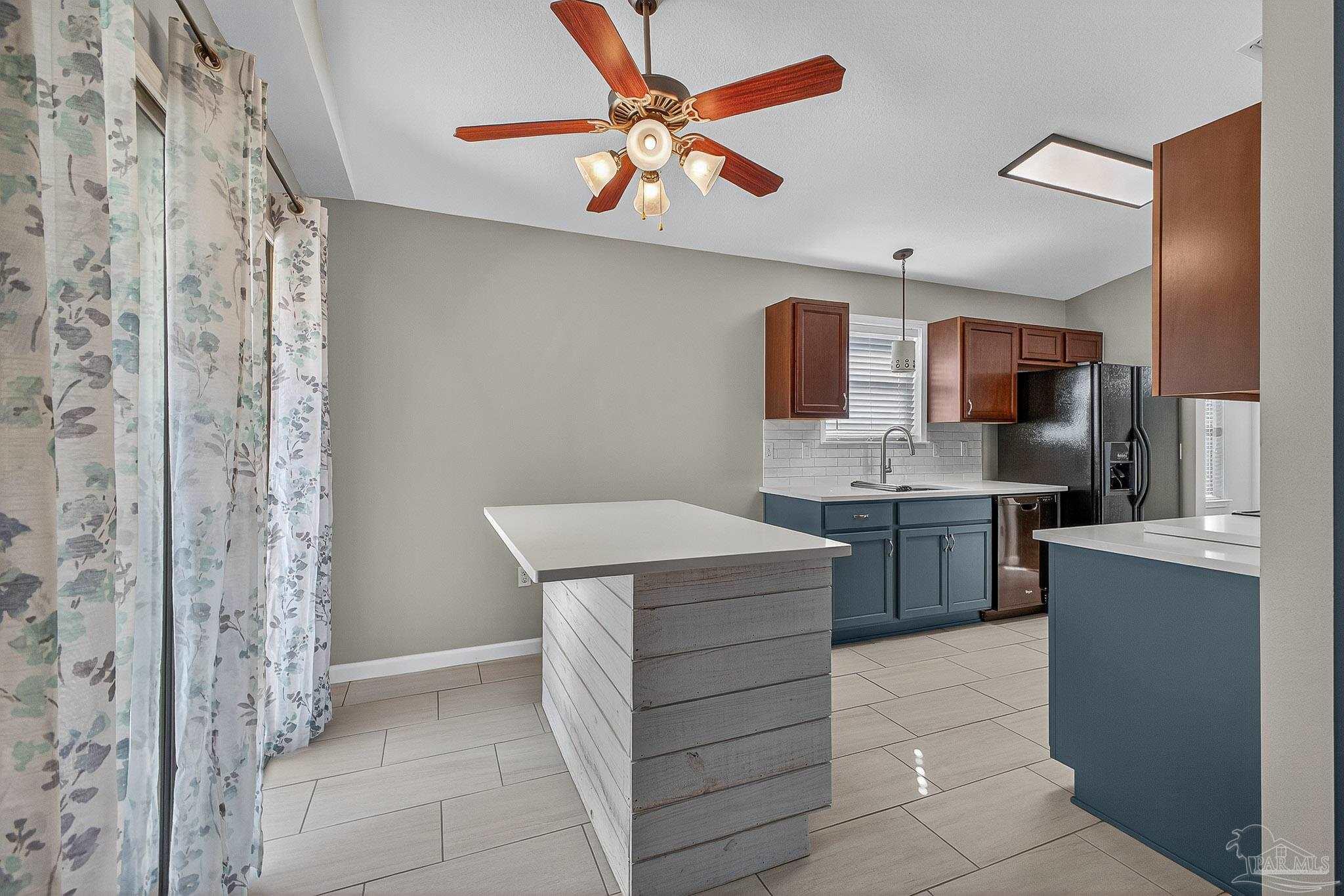 272 Millet Circle Cantonment, FL 32533 - Photo 10 of 57 a kitchen with stainless steel appliances a sink and a refrigerator